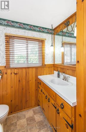 Port Colborne (Sugarloaf) apartment for rent - A bathroom with wooden walls and a checkered floor.
