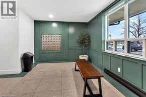 Brantford condo for rent - A room with a green wall and a wooden bench.