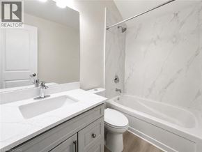 Ancaster apartment for rent - A white bathroom with a marble patterned wall.