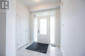 Wasaga Beach apartment for rent - A hallway with a door and a mat on the floor.