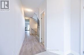 Wasaga Beach apartment for rent - A long hallway with a staircase on the right side.