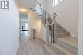 Wasaga Beach apartment for rent - A staircase with a metal railing and wooden steps.