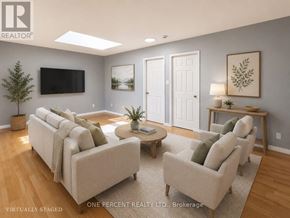 Hamilton (Eastmount) house for rent - A living room with a couch, chairs, and a television.