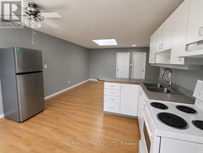 Hamilton (Eastmount) house for rent - A kitchen with a refrigerator, stove, and sink.