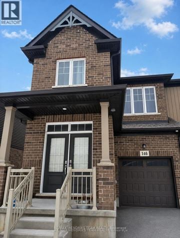 Thorold (Confederation Heights) townhouse for rent - A house with a black front door and a garage door.