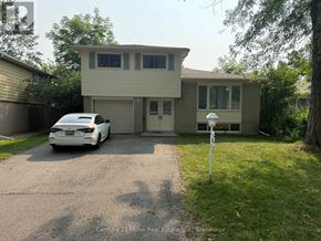 Brampton (Brampton East) apartment for rent - A white car is parked in front of a two-story house.