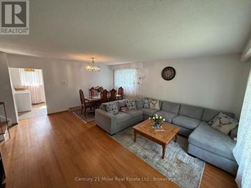 Brampton (Brampton East) apartment for rent - A living room with a grey couch and a wooden coffee table.