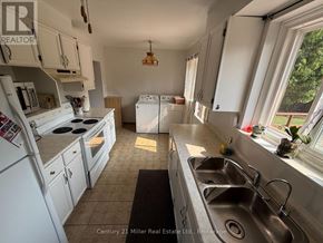 Brampton (Brampton East) apartment for rent - A kitchen with white appliances and cabinets is for sale.
