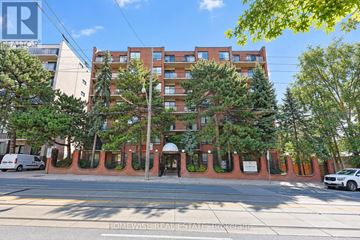 Toronto (The Beaches) multi-family for rent - A building with a red brick facade and a white van parked in front.