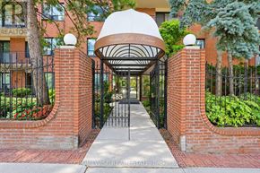 Toronto (The Beaches) multi-family for rent - A red brick wall with a gate and a white archway above it.