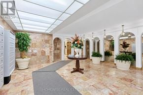 Toronto (The Beaches) multi-family for rent - A hallway with a marble floor and a glass ceiling.