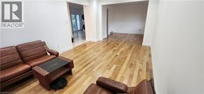 Kitchener apartment for rent - A living room with a brown leather couch and coffee table.
