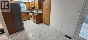 Kitchener apartment for rent - A kitchen with a refrigerator and a sink.