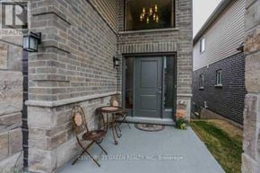 London North (North C) apartment for rent - A patio with a table and chairs is in front of a brick building.