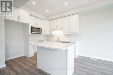 Niagara Falls (Morrison) townhouse for rent - A kitchen with white cabinets and a white island.