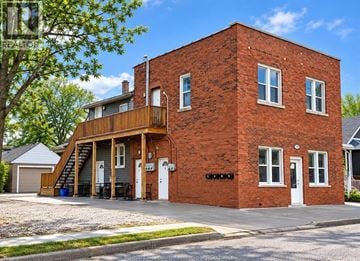 Windsor apartment for rent - A red brick house with a white door and windows.