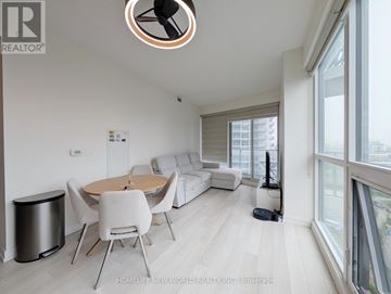 Toronto (Bayview Village) condo for rent - A modern living room with a dining table and chairs.