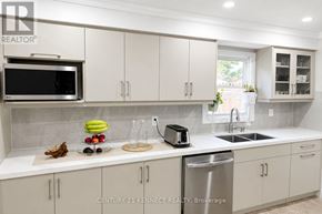 Brampton (Heart Lake West) apartment for rent - A modern kitchen with white cabinets and a stainless steel sink.