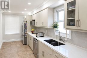 Brampton (Heart Lake West) apartment for rent - A kitchen with white cabinets and a black sink.