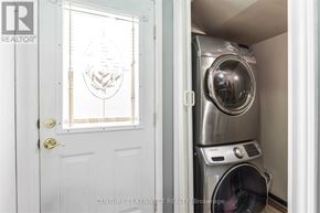 Brampton (Heart Lake West) apartment for rent - A washing machine is in a small laundry room.