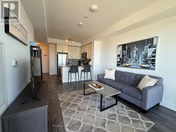 Milton (De Dempsey) condo for rent - A living room with a grey couch and a coffee table.