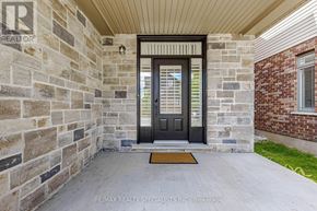 Guelph (Victoria North) apartment for rent - A house entrance with a stone wall and a black door.