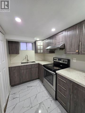 Toronto (Wexford-Maryvale) apartment for rent - A kitchen with a stove top oven and a sink.