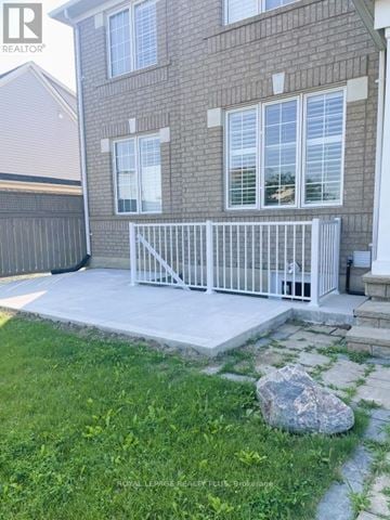 Milton (Cl Clarke) apartment for rent - A house with a white fence and a rock in the front yard.
