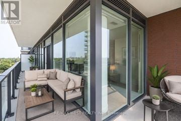 Toronto (Humber Heights) condo for rent - A balcony with a couch, coffee table, and potted plant.