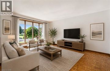 Cambridge apartment for rent - A living room with a couch, a coffee table, a television, and a window with a view of the outdoors.