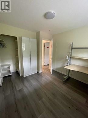 Columbia Valley apartment for rent - A room with a wooden floor and a white door.
