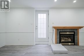 Pickering (Amberlea) apartment for rent - A room with a fireplace and a door.