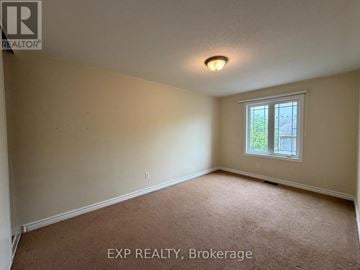 Ottawa townhouse for rent - A room with a carpeted floor and a window.