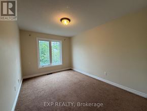 Ottawa townhouse for rent - A room with a window and carpeted floor.