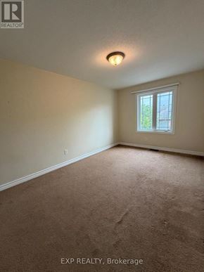Ottawa townhouse for rent - A room with a carpeted floor and a window.