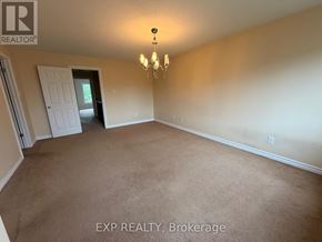 Ottawa townhouse for rent - A room with a carpeted floor and a chandelier hanging from the ceiling.