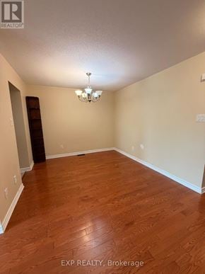 Ottawa townhouse for rent - A room with wooden floors and a chandelier.