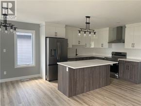 Azilda apartment for rent - A modern kitchen with a large island in the center.
