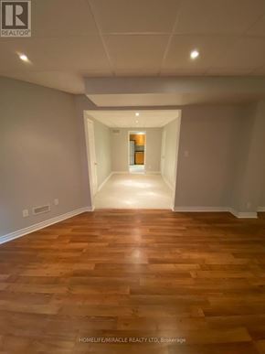 Vaughan (Islington Woods) multi-family for rent - A hallway with wooden floors and white walls.