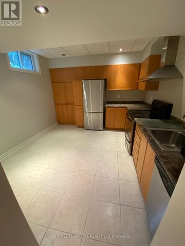 Vaughan (Islington Woods) multi-family for rent - A kitchen with wooden cabinets and a stainless steel dishwasher.