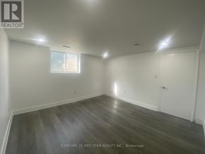 Toronto (Elms-Old Rexdale) apartment for rent - A room with wooden flooring and white walls, with a window and a door.