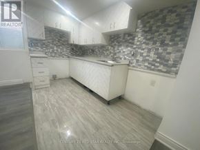Toronto (Elms-Old Rexdale) apartment for rent - A kitchen with a checkered backsplash and wooden flooring.