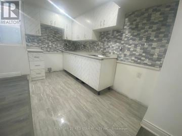 Toronto (Elms-Old Rexdale) apartment for rent - A kitchen with a checkered backsplash and wooden flooring.