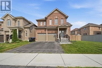 Bradford West Gwillimbury (Bradford) apartment for rent - A large brick house with a driveway in front.