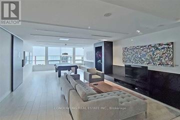 Toronto (Regent Park) condo for rent - A modern living room with a large couch and a television.