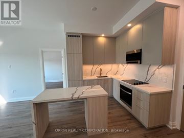 Vaughan (Vaughan Corporate Centre) condo for rent - A kitchen with a marble countertop and wooden cabinets.