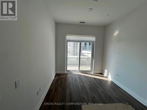 Vaughan (Vaughan Corporate Centre) condo for rent - A room with a large window and wooden floors.