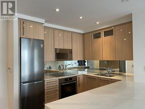 Toronto (Annex) condo for rent - A modern kitchen with wooden cabinets and stainless steel appliances.