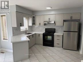 Mississauga (Meadowvale Village) apartment for rent - A kitchen with white cabinets and a marble countertop.