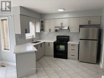Mississauga (Meadowvale Village) apartment for rent - A kitchen with white cabinets and a marble countertop.